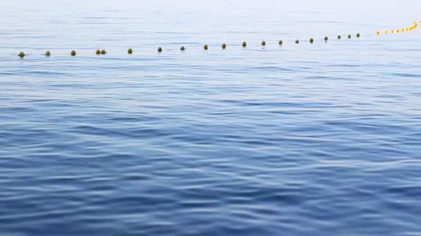 Small Motor Boat Approaching Buoy Markers Dividing Swimming Safe Area — Stock video