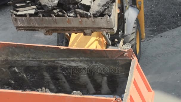 Cold planer machine loading milled asphalt into dump truck.Road works. Asphalt milling machine in action — Stock Video