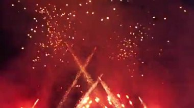 Koyu mavi gökyüzünde şenlikli bir selamın kırmızı kıvılcımları. Neşeli arkaplan