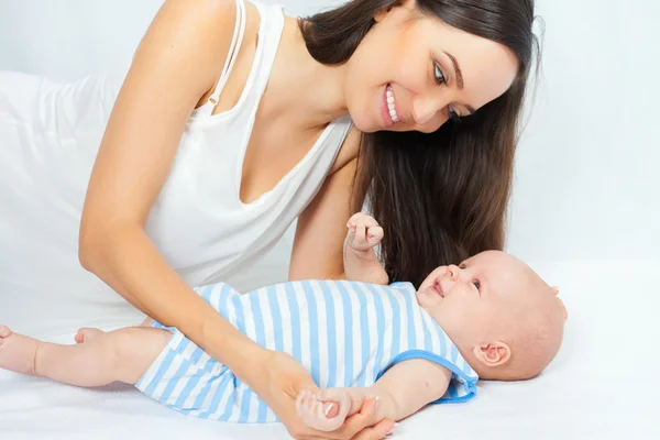Ibu bahagia menggendong bayi laki-laki dengan latar belakang putih — Stok Foto