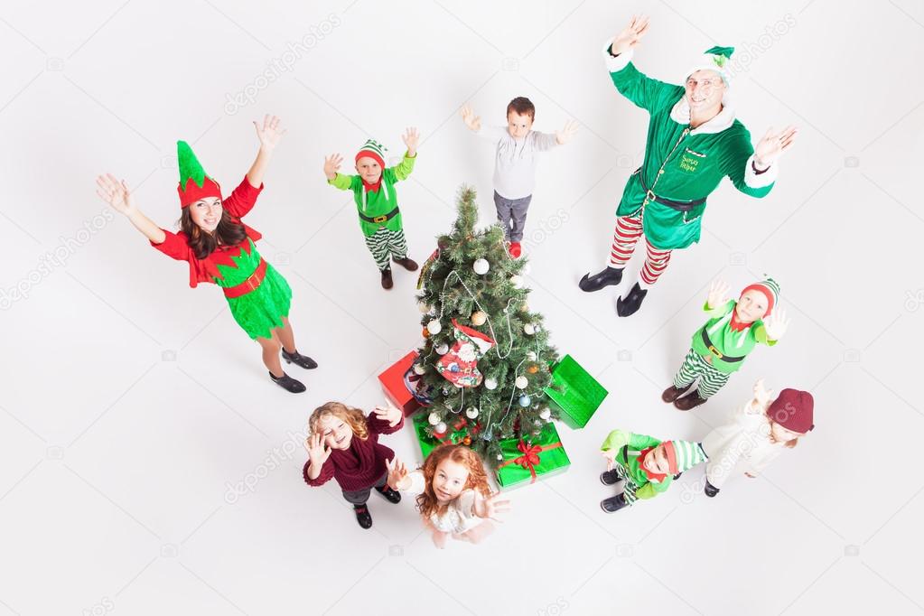 Happy family celebrating Christmas near Cristmas tree.