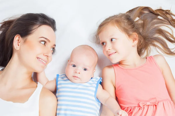 Happy mother with her children looking at camera — Stock Photo, Image