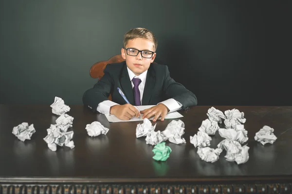 Geïnspireerd school jongen schrijven essay of examen — Stockfoto