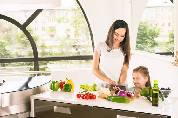 Gadis kecil yang lucu memasak dengan ibunya di dapur — Stok Foto