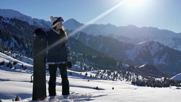 Snowboarder successful young woman adventure to snowy alps mountains, Swiss. Snowboard and ski healthy activities. Footage — Stock Video
