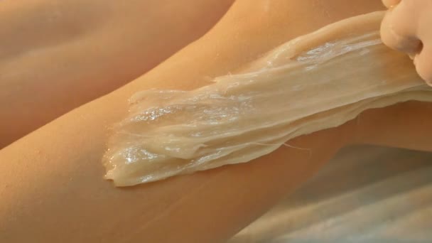 Sugaring epilation skin care with liquid sugar at legs — Stock Video