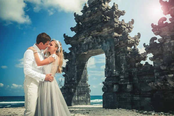 Retrato de pareja feliz cerca de la puerta tradicional. Viajar a Bali — Foto de Stock