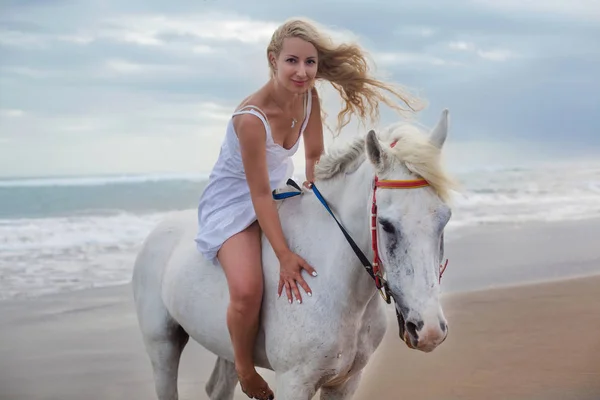 Gyönyörű fiatal nő séta a ló, a strandon, lovaglás — Stock Fotó