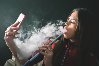 Genç, güzel bir kız duman bir nargile Club