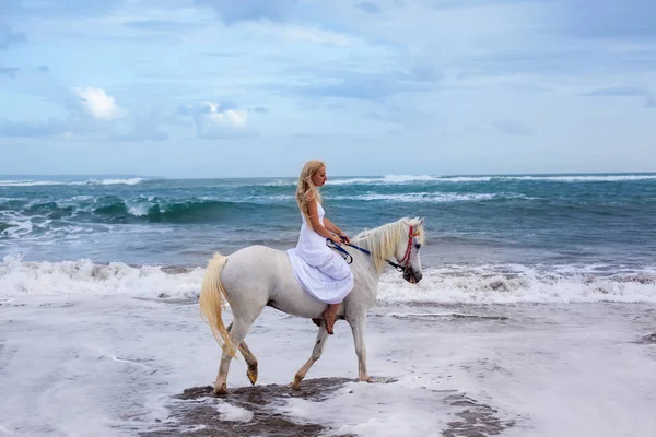 Schöne junge Frau zu Fuß mit Pferd am Strand, zu Pferd — Stockfoto