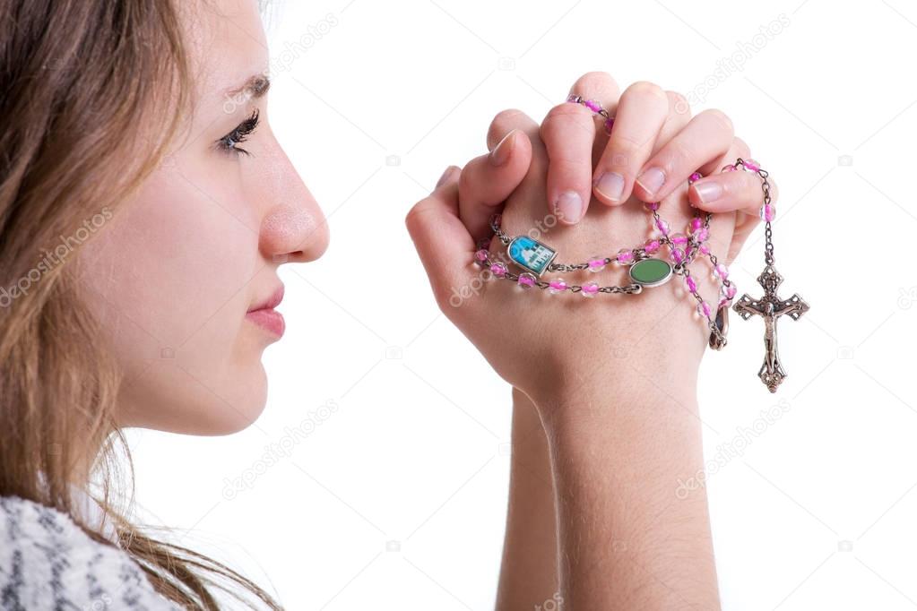 Girl praying with rosary
