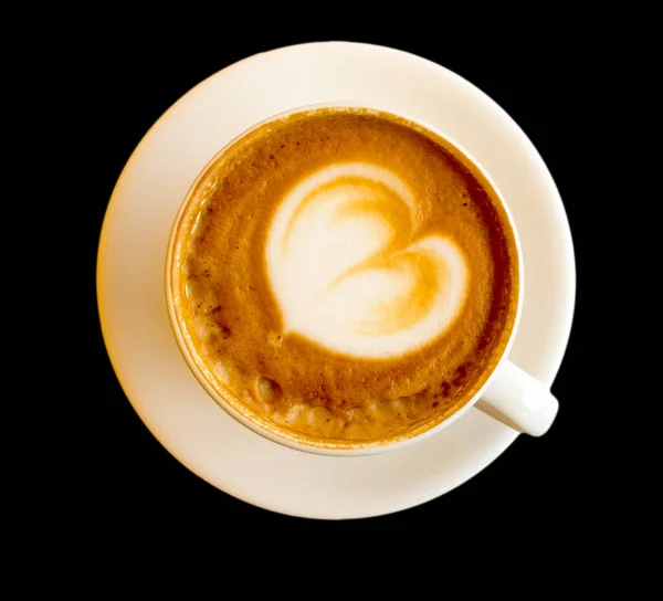 Saucer and Cup with cappuccino coffee, with a pattern of foam in the form of a heart, isolated on a black background