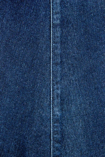 Close up of details of denim skirt trousers with  stitches.  seam on denim skirt.