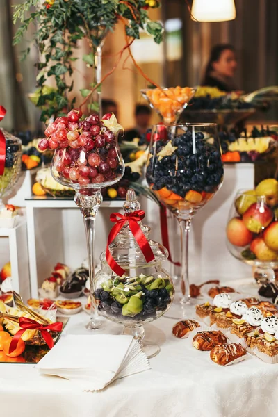 Grape in the huge wineglasses  on the table with sweets — Stock Photo, Image