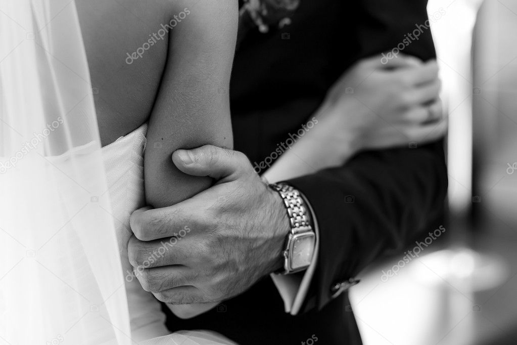 Fiance's hand holds bride's elbow