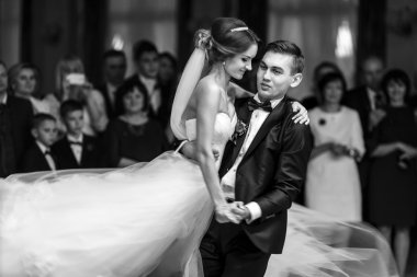 Fiance turns bride around in a dance  clipart