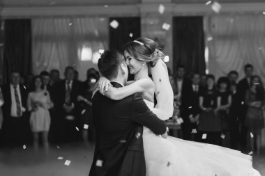 Bride hugs fiance while dancing in the restaurant  clipart