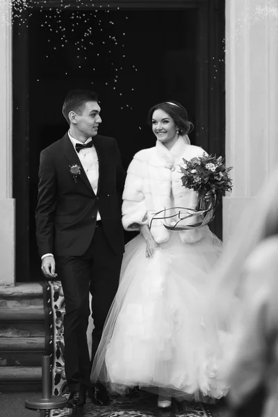 Just married walk out from the church after the ceremony