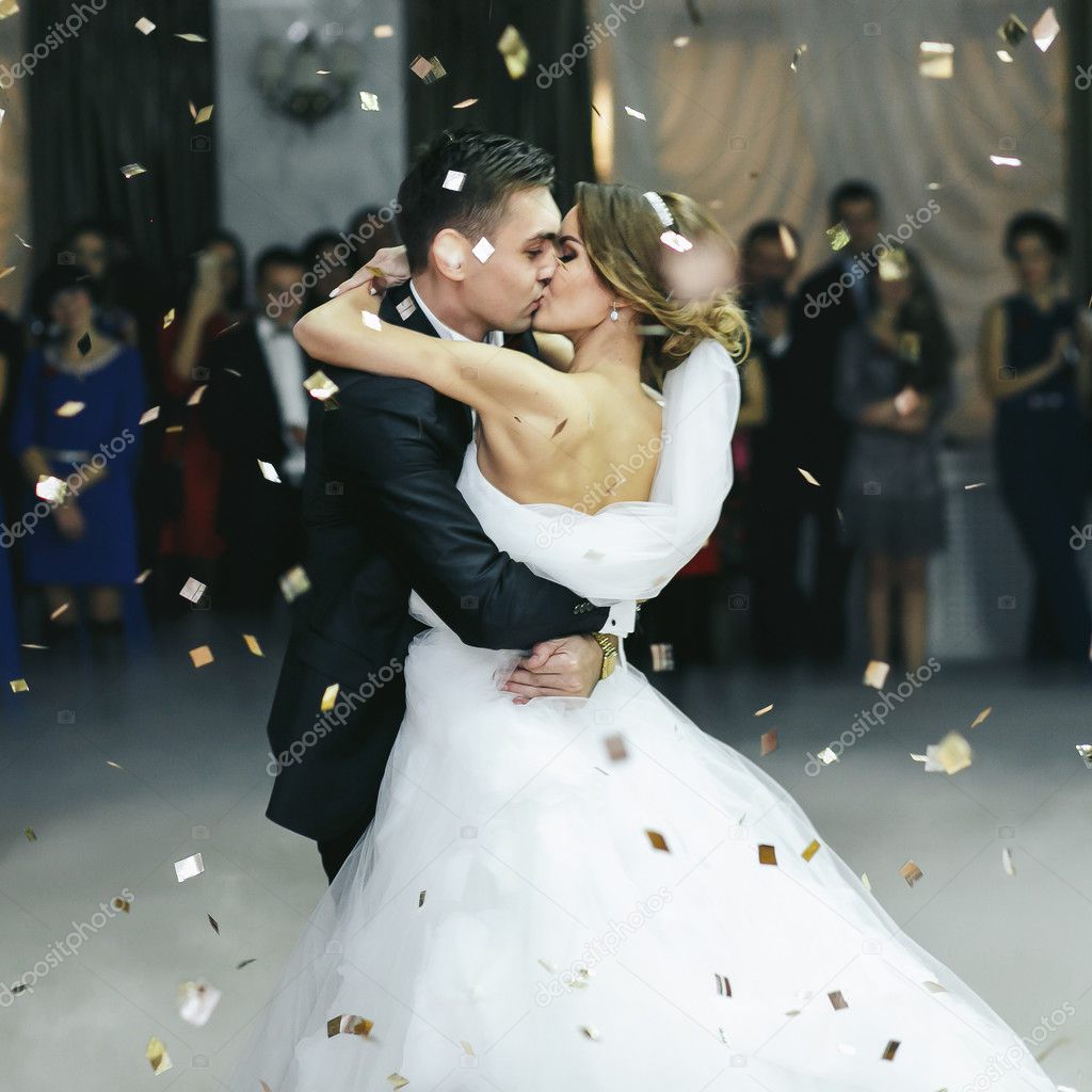 Just married kiss in the thick smoke and the rain of confetti 