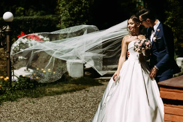 Bride in the long veil in the windy day — Stock Photo, Image