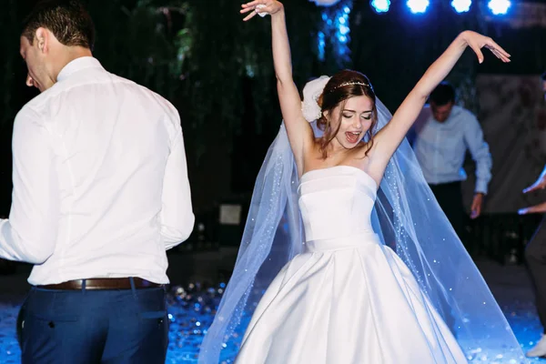 Lustige Bewegungen der Braut im Schleier auf der Hochzeit — Stockfoto