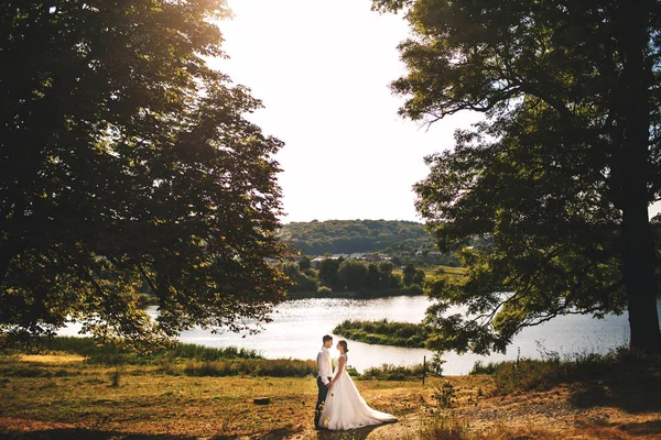 Par i kärlek stående nära lake — Stockfoto