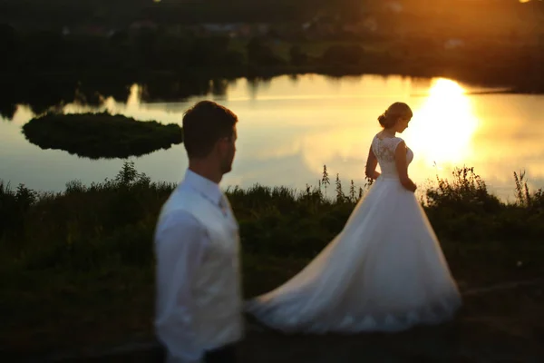 The lovely  brides stand near lake — Stock Photo, Image