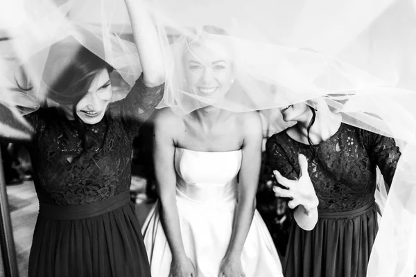 Menyasszony és a koszorúslány szórakozást rejtőzik egy fátyol — Stock Fotó