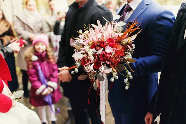 A view on an autumn wedding bouquet held by a groom — Stock Photo, Image