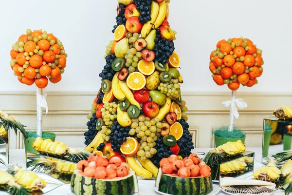 A closeup of a pyramid made of fruits and balls made of watermel Stock Picture