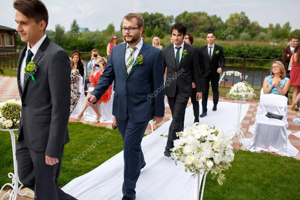 Groomsmen march to the wedding altar 