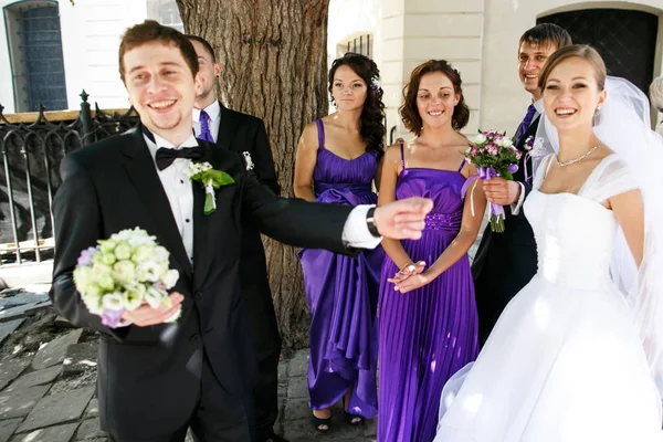 Just married couple has fun while walking with their friends — Stock Photo, Image