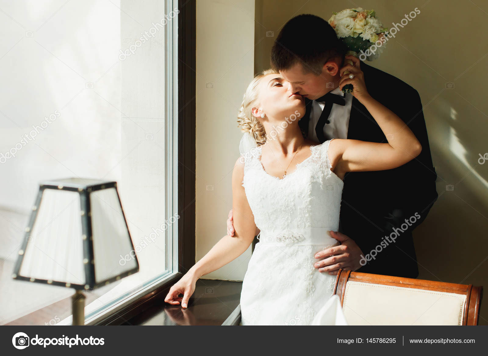 Bride Kisses A Groom While He Hugs Her From Behind Standing In T Stock Photo Image By C Ivash Bride Kisses A Groom While He Hugs Her From Behind Standing In T Stock Photo Image By C Ivash