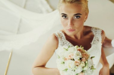 Gelin düz piyanoda eğilerek kameraya görünüyor