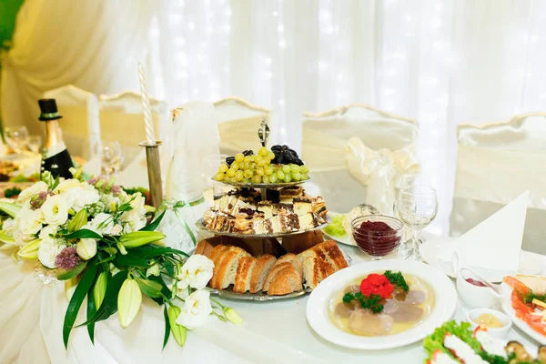 Luxury dinner table with drinks, pastry and meat