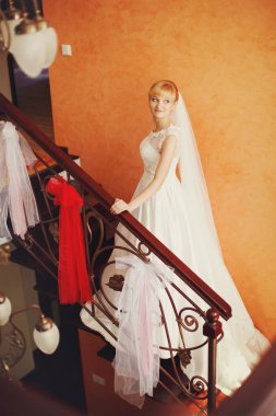 Merdivenlerin üzerinde duran bir güzel sarışın gelin bir görünüm 