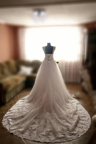 The wedding dress stands near room