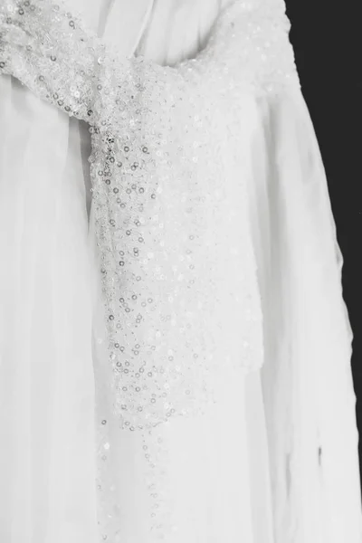 A veil belt with crystals hangs on a white dress — Stock Photo, Image