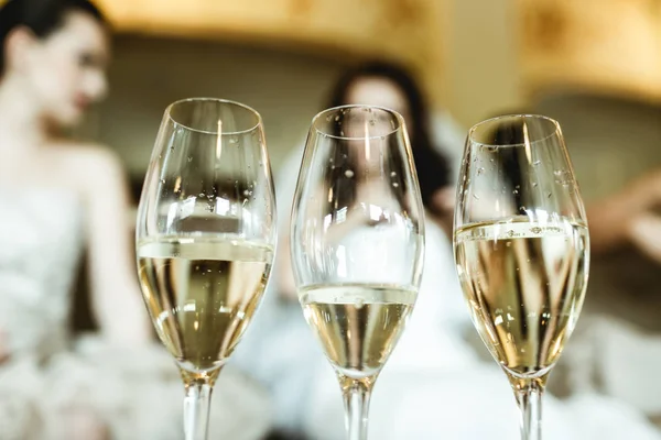Bril met champagne staan op de tabel in de voorkant van bruid — Stockfoto