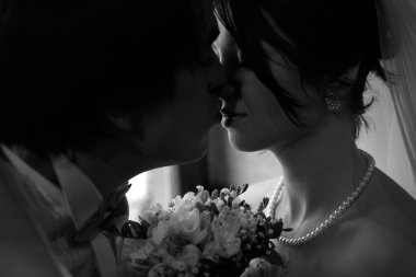 Bir damat gelin öpücüğü vermeye bir siyah beyaz resim 