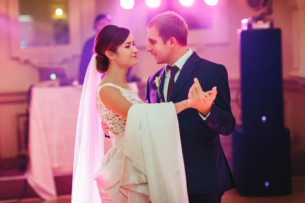 Groom holds bride's waist tender dancing with her at the first t — Stock Photo, Image