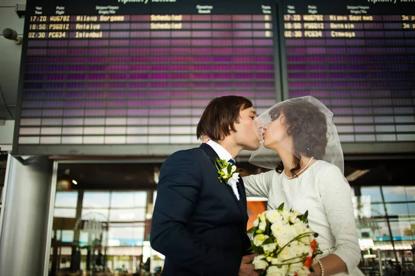 Groom kisses a bride hidden under a short veil — Stock Photo, Image