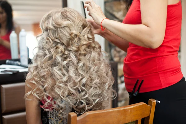 A look from behind on the woman with gorgeous blonde curls