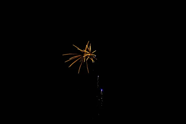 Yellow fireworks sparkles in the black sky — Stock Photo, Image