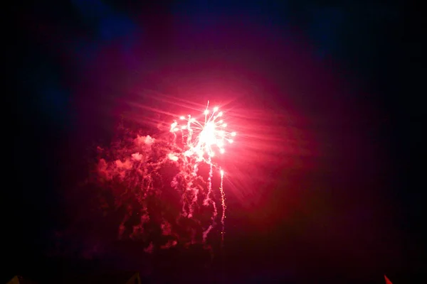 Red fireworks shine like a sun in dark blue sky — Stock Photo, Image