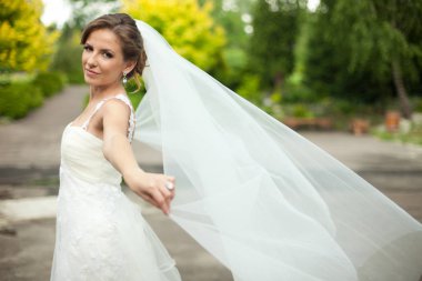 O bir yaz parkta poz iken gelin peçe Rüzgar esiyor