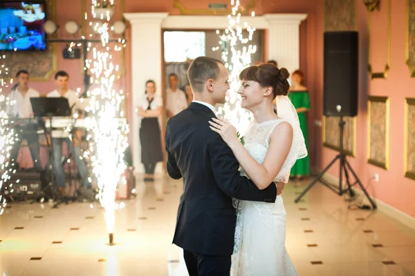 Happy wedding couple dances between Bengal fires