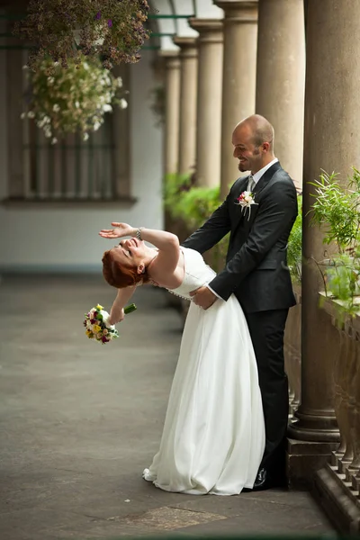 La mariée regarde par-dessus son épaule pendant que le marié l'attend — Photo