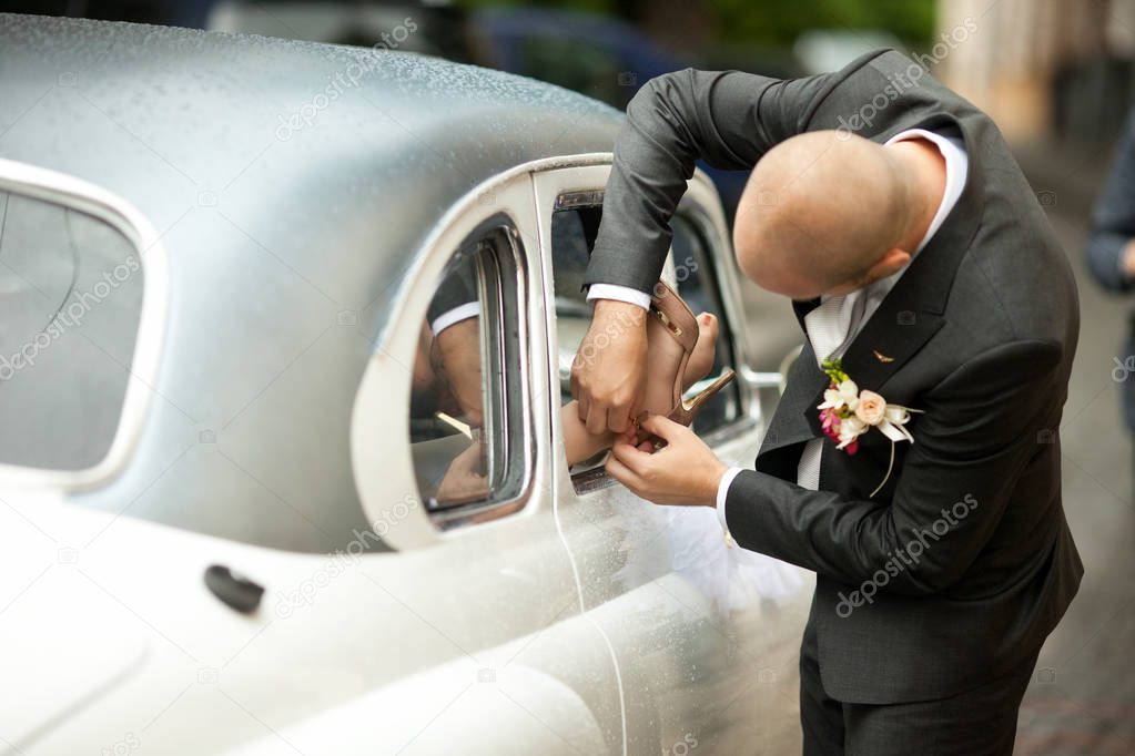 Bride looks over her shoulder while groom waits for her