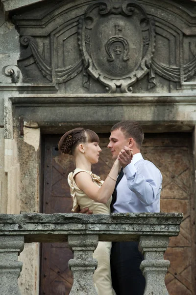 Man holds woman hand for a dance standing in the front of an old — Stock Photo, Image